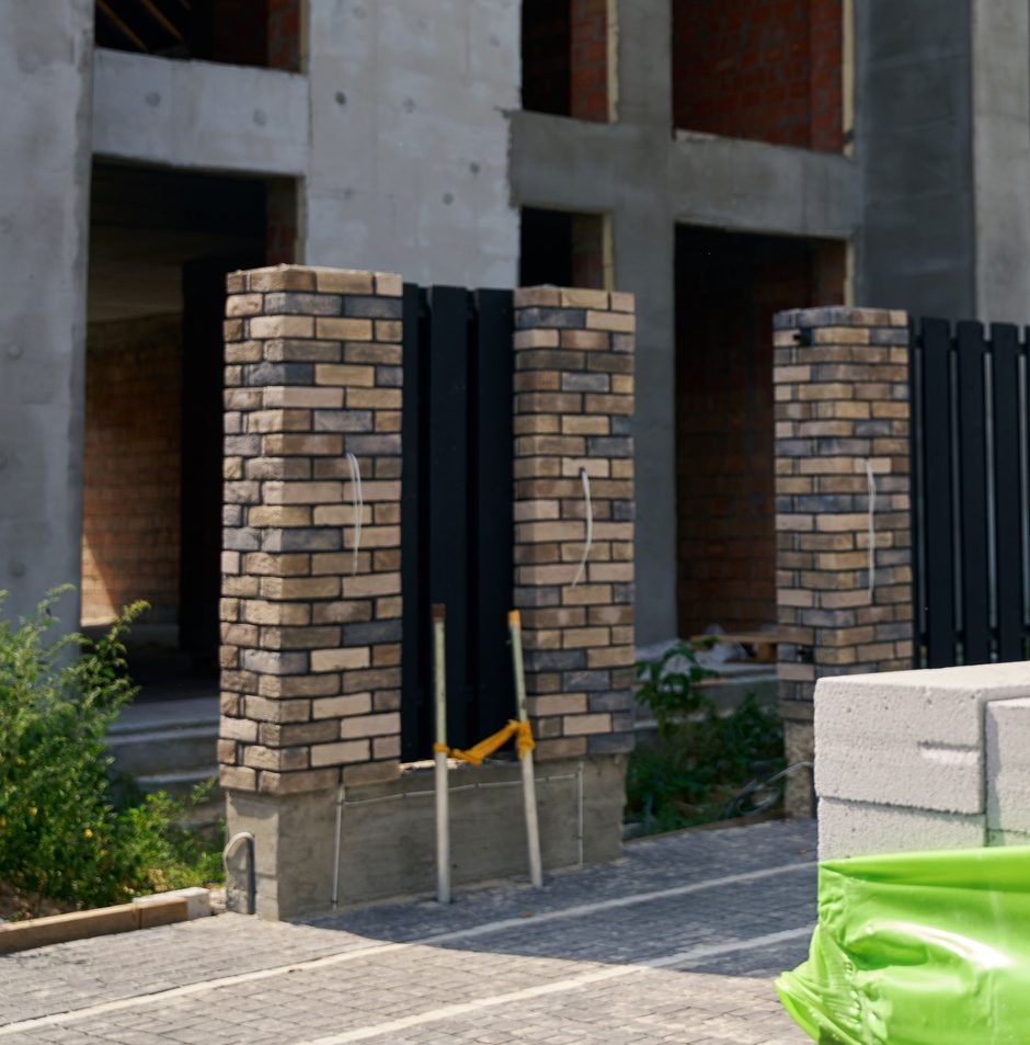 Construction worker is examining concrete paver block for masonry work