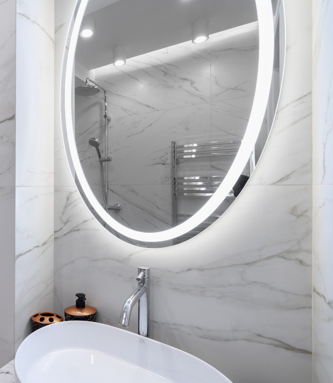 White bathroom interior with marble tiles on the walls